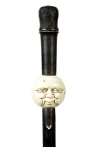233.Ivory Man In The Moon Cane- Early 20th Century-A: 233.Ivory Man In The Moon Cane- Early 20th Century-A carved ivory man in the moon with baby blue two colored eyes, black horn handle ebony twigspur shaft with ivory tips and a brass ferrule, H.2”x