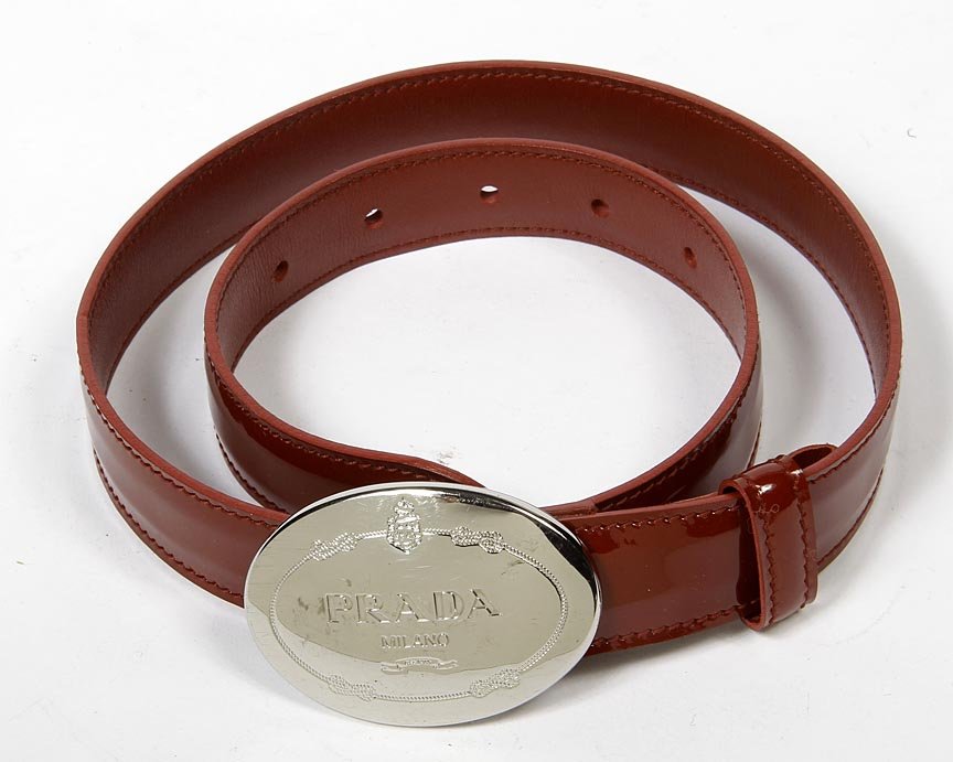 Prada-Narrow red patent leather bed with silver oval: Prada-Narrow red patent leather bed with silver oval buckle with logo. Up to 28" waist.