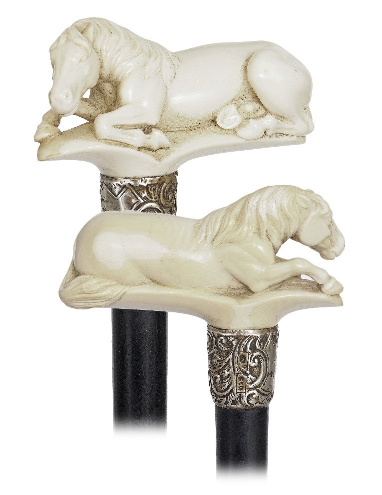 10. Ivory Horse Cane-Hallmarked 1884-Large and fine: 10. Ivory Horse Cane-Hallmarked 1884-Large and fine grained ivory handle carved to depict a resting horse, ebony shaft with a well chased silver collar struck with London hallmarks 1884 and a stag hor