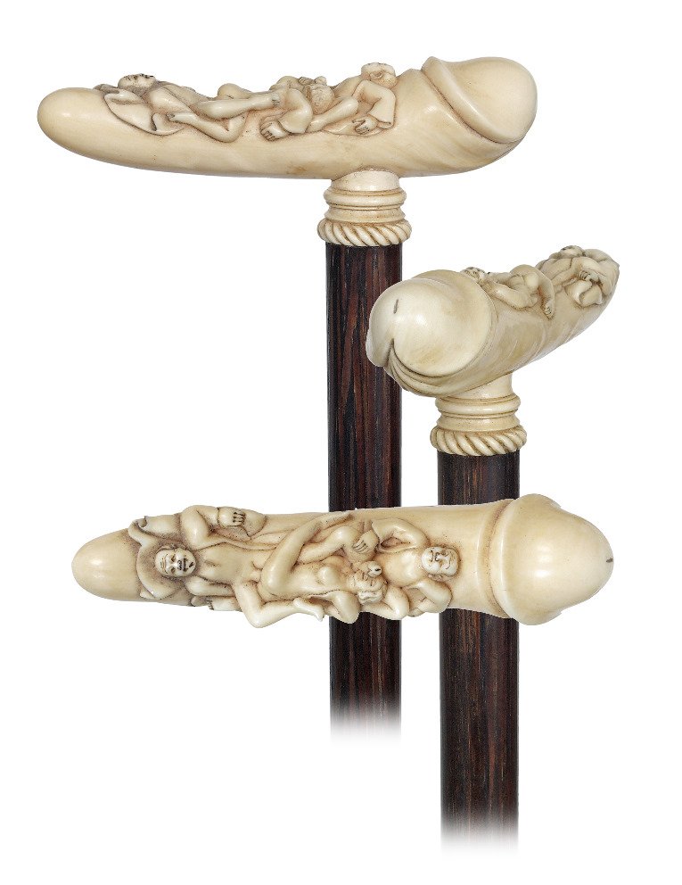 36. Ivory Erotic Cane-Ca. 1900-The ivory handle is: 36. Ivory Erotic Cane-Ca. 1900-The ivory handle is fashioned to depict an erected male organ with a woman engaged in an erotic embrace with two men. The handle, with a winning combination of sculptura