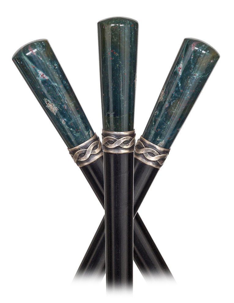 38. Heliotrope Dress Cane -Ca. 1900-Straight heliotrope: 38. Heliotrope Dress Cane -Ca. 1900-Straight heliotrope handle of the desirable deep green tint with striking and natural varicolored inclusions. Ebony shaft with white metal collar and a horn ferrule