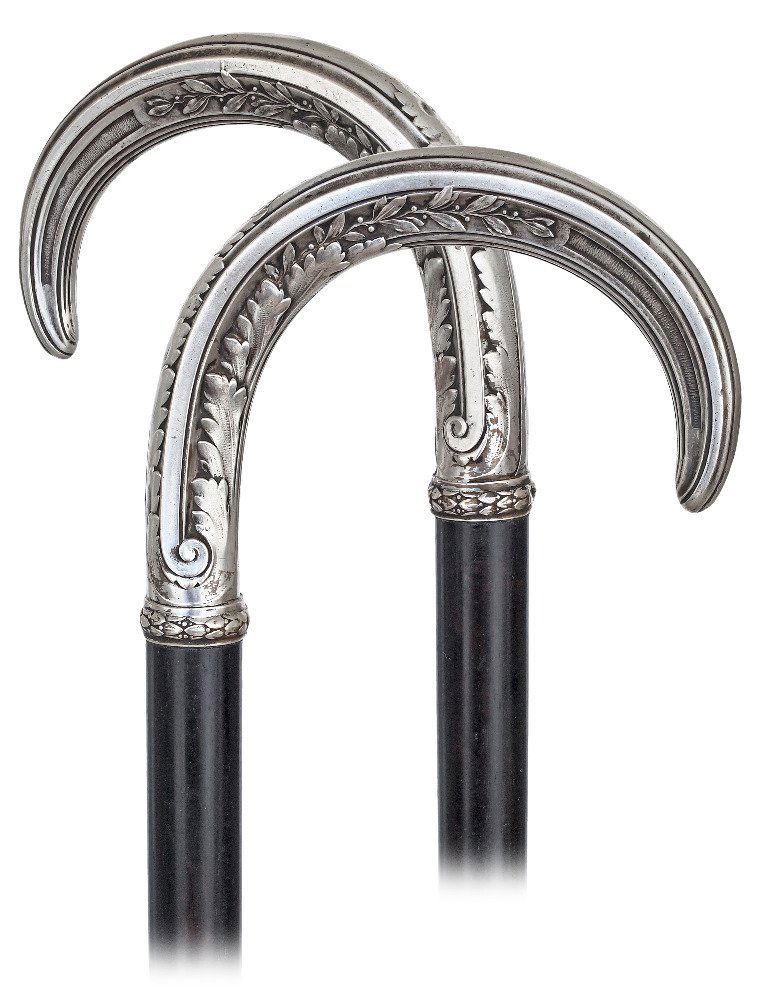 79. Silver Dress Cane-Ca. 1880-Well-proportioned and: 79. Silver Dress Cane-Ca. 1880-Well-proportioned and large silver crook handle hand chased and engraved with various oak leaves and laurel panels, ebony shaft and a metal ferrule. Top rate German qual