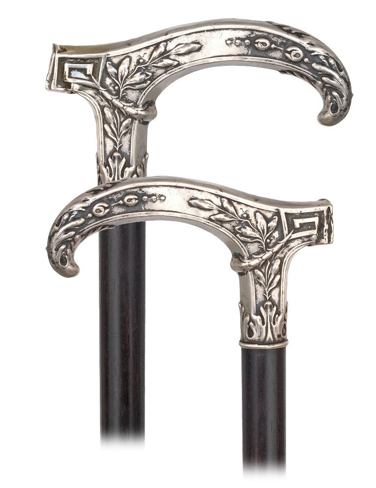 118. Silver Dress Cane-Ca. 1900-Elegant Opera shaped: 118. Silver Dress Cane-Ca. 1900-Elegant Opera shaped silver handle with a pointed and down curving nose, ebony shaft and a horn ferrule. The handle of a pleasing, slightly angular cut is richly hand c