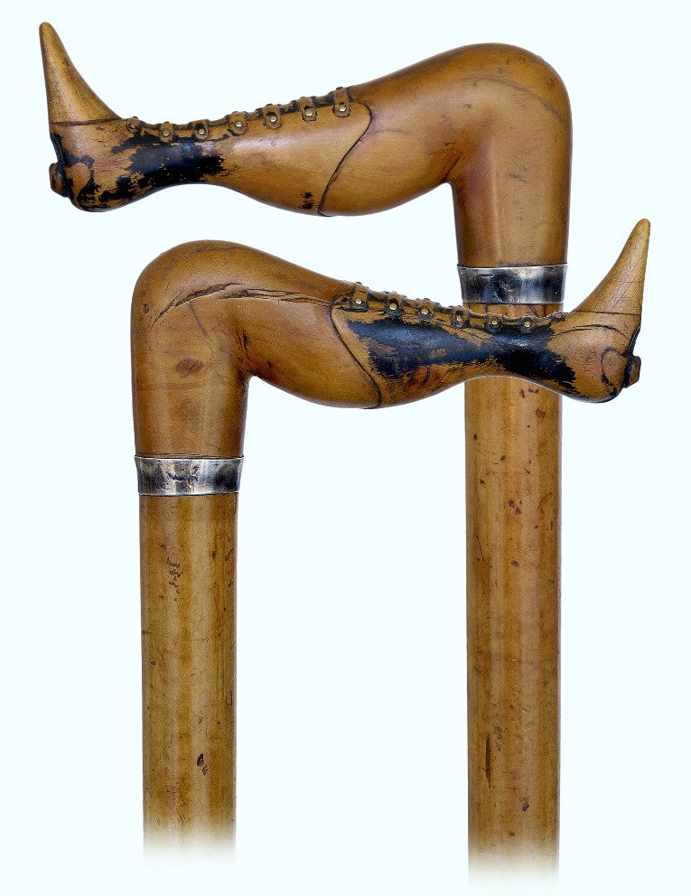 132. Folk Art Naughty Leg Cane-Ca. 1880-Boxwood leg: 132. Folk Art Naughty Leg Cane-Ca. 1880-Boxwood leg with boots emphasized with brass nails and black color, full bark malacca shaft with a silver collar and a metal ferrule. Victorian, mildly erotic c