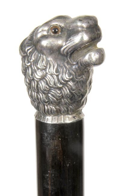 157. Silver Lion Cane-Early 20th Century-A cast silver: 157. Silver Lion Cane-Early 20th Century-A cast silver lion with two color glass eyes, ebony shaft and a horn ferrule-H. 1 ¼” x 1 ½”, O.L. 36”
