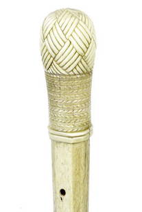 3. Nautical Whalebone Cane-Ca. 1840-A carved whale’s: 3. Nautical Whalebone Cane-Ca. 1840-A carved whale’s tooth “Turk’s Knot” and rope handle, 1 ¼” whalebone shaft with cared eyelets, carved 6 sided shaft to the mid section then to a 4 sided