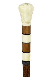 17. Whale’s Tooth Nautical Cane-Ca. 1850-A large carved: 17. Whale’s Tooth Nautical Cane-Ca. 1850-A large carved whale’s tooth handle, exotic wood and baleen spacers, a pair of whale ivory inserts, coin silver collar, cocoanut wood shaft and a 2 ½”