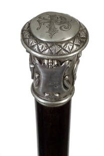 24. Silver Dress Cane-Ca. 1900-An unsigned silver: 24. Silver Dress Cane-Ca. 1900-An unsigned silver handle in high relief which has various horse racing equipment and horses including helmets, saddles, exotic wood shaft and a horn ferrule-H. 1 ¼”