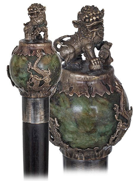 95. Shishi Mascot Cane-Early 20th Century-Jade ball: 95. Shishi Mascot Cane-Early 20th Century-Jade ball knob in a white metal cage, partly silver and partly gilt, consisting of three dragons and topped by the Imperial guardian lion Shishi, ebony shaft