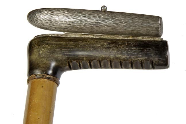 143. Cigar Container Cane-Late 19th Century-An unusual: 143. Cigar Container Cane-Late 19th Century-An unusual cigar (Cheroot) holder, locking silver metal top, Howell of London cartouche is attached to the malacca shaft and a horn ferrule-H. 4 ¾” x 2��