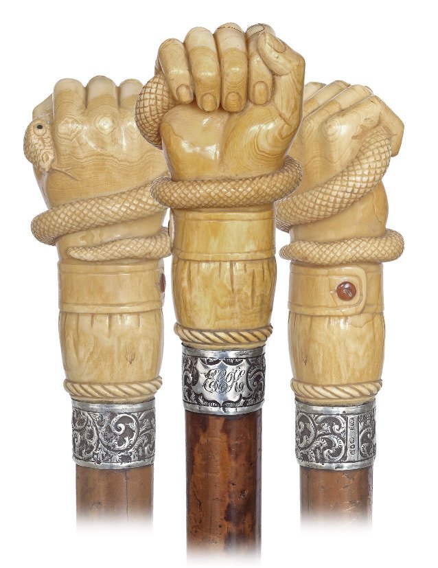 44. Top Rate Marine Cane-Ca. 1860-Substantial whale: 44. Top Rate Marine Cane-Ca. 1860-Substantial whale tooth knob well carved as a fist with a buttoned cuff and a coiled snake with a large head and forked tongue, well chased and engraved silver coll