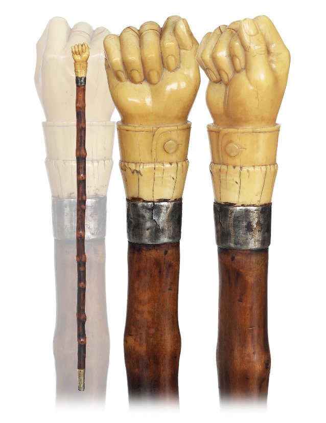 19. Top Rate Marine Cane-Ca. 1850-Substantial whale: 19. Top Rate Marine Cane-Ca. 1850-Substantial whale tooth knob well carved as a fist with a buttoned cuff, plain silver collar on a blackthorn branch shaft freed from its bark and with naturally black