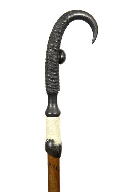 236. Jungfrau Hiking Stick- Ca. 1910- A typical hiking: 236. Jungfrau Hiking Stick- Ca. 1910- A typical hiking stick of this type with a goat horn handle, goat leg and hoof collar, maple shaft and pike ferrule H- 6 ½” x 3 ½” O.L- 39” $250-$35