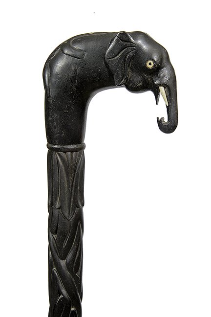1. Johnny Winter Rock/Roll Cane- 20th Century- A carved: 1. Johnny Winter Rock/Roll Cane- 20th Century- A carved ebony elephant with a pair of bone tusks, carved lizard atop with inlaid eyes, fully carved shaft and a bone ferrule. This cane can be seen on