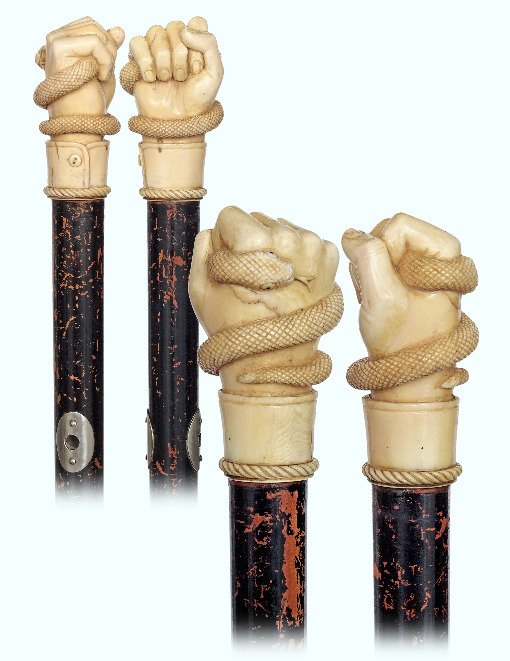 28. Top Rate Marine Cane-Ca. 1860-Sizeable whale tooth: 28. Top Rate Marine Cane-Ca. 1860-Sizeable whale tooth knob well carved in a seldom encountered high relief as a fist with a buttoned cuff and a coiled snake with a large head and forked tongue, black