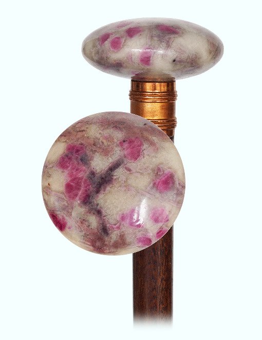45. Ruby Dress Cane-Early 1900s-Large, round and: 45. Ruby Dress Cane-Early 1900s-Large, round and precious hard stone fuchsite knob of a pale green color with naturally embedded red ruby crystals, rosewood shaft with a grooved yellow metal collar an