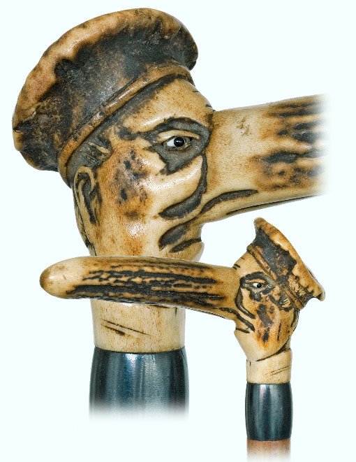 64. Peculiar Jewish Character Cane-Ca. 1900-Figural: 64. Peculiar Jewish Character Cane-Ca. 1900-Figural stag horn handle carved to depict a man’s head with a long nose out of proportions. The essence of the head is exaggerated and distorted to create