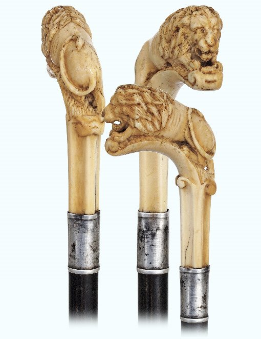 76. Ivory Lion Cane-19th Century-Ivory handle depicting: 76. Ivory Lion Cane-19th Century-Ivory handle depicting a majestically upright male in the Gothic taste, ebonized hardwood shaft with a plain silver collar and a metal ferrule. Excellent portrait of t