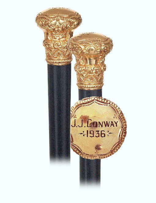105. Gold American Presentation Cane-Ca. 1900-Large: 105. Gold American Presentation Cane-Ca. 1900-Large gold rolled knob in the customary waisted shape with multiple, integral collars richly modeled with repeating panels of floral and scrollwork and en