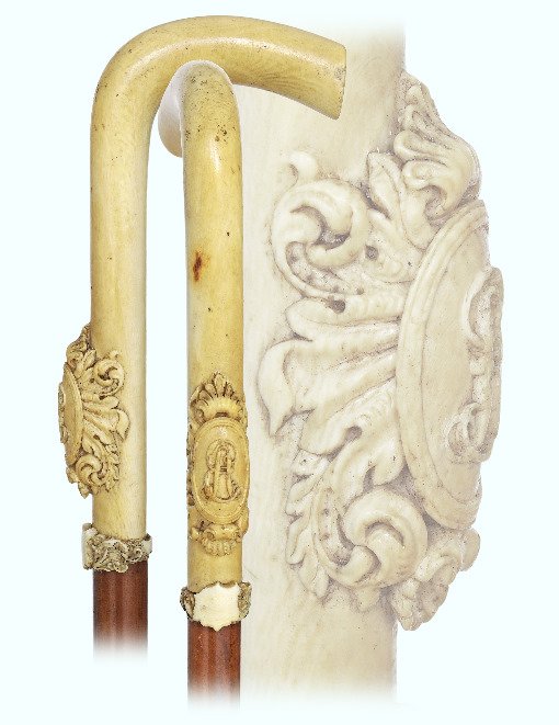 106. Ivory Dress Cane-Ca. 1870-L-shaped ivory handle: 106. Ivory Dress Cane-Ca. 1870-L-shaped ivory handle carved in very high relief with an integral escutcheon personalized with “EA” feathery initials, malacca shaft with an ivory collar and 2 ¾”