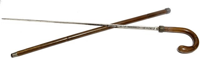 197. Best Toledo Sword- Late 19th Century- A hard: 197. Best Toledo Sword- Late 19th Century- A hard bamboo crook handle with a basket woven silver collar, highly engraved and mint 27 ” Toledo blade with a push and turn mechanism which works perfect