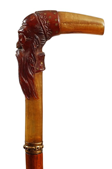 67. Horn Sword Cane- Ca. 1880- A horn mounted wizard: 67. Horn Sword Cane- Ca. 1880- A horn mounted wizard handle which appears to be rhino with various inlaid stars, ornate gold metal collar, push button 12” four sided etched dagger in fine condition,