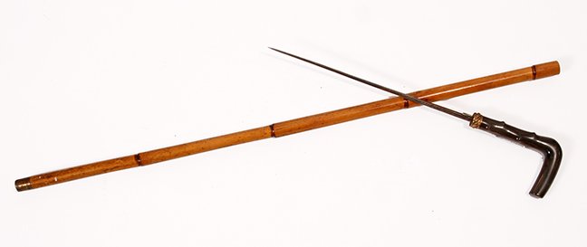 1. Horn Sword Cane- Ca. 1885- A twigspur horn handle,: 1. Horn Sword Cane- Ca. 1885- A twigspur horn handle, ornate gold filled collar, stepped bamboo shaft, brass ferrule, etched 11 ½” four sided blade, blued and gilded with push button mechanism, H.