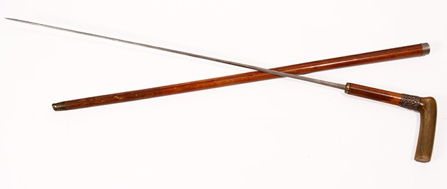 10. Horn Sword Cane- Ca. 1880- A polished horn handle,: 10. Horn Sword Cane- Ca. 1880- A polished horn handle, ornate sterling collar, silver metal lower collar, malacca shaft, brass ferrule, 226 ½” four sided blade with push and pull mechanism. H- 2 ½