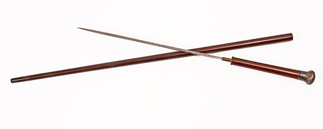 21. Silver Sword Cane- Ca. 1885- An ornate unsigned: 21. Silver Sword Cane- Ca. 1885- An ornate unsigned silver handle, carved wood collar, mahogany shaft, horn ferrule, 15 ½” four-sided, etched, intaglio blade with push and pull mechanism. H.- 1 ½�