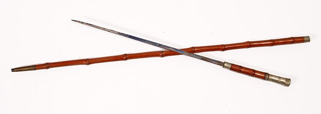 36. Sword Cane-Ca. 1880- A simple but efficient sword: 36. Sword Cane-Ca. 1880- A simple but efficient sword cane with nickel silver collars and handle, split bamboo shaft and a burly brass 2” ferrule, 15” two-sided, etched blade with push/pull mechan