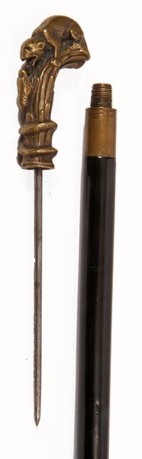 40. Mongoose and Snake Sword Cane- Ca. 1930- A cast: 40. Mongoose and Snake Sword Cane- Ca. 1930- A cast bronze handle which doubles as a bludgeon cane, brass collar, ebonized shaft, copper ferrule, 5” spike blade with screw mechanism. H.- 3 ¼” x 1