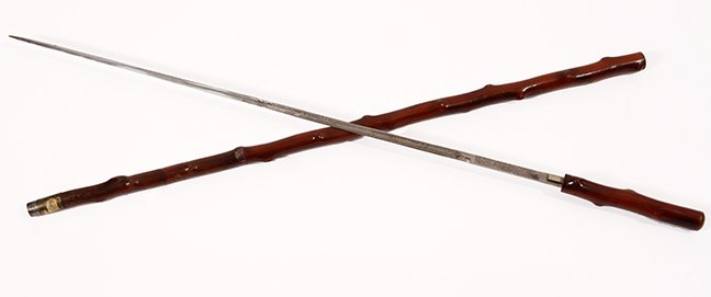 54.Twigspur Sword Cane- Ca. 1850- A natural twigspur: 54.Twigspur Sword Cane- Ca. 1850- A natural twigspur branch with a hidden push button mechanism in one spur, original patina, fancy brass and metal ferrule, 27” blade engraved “ Peace with Honor, 