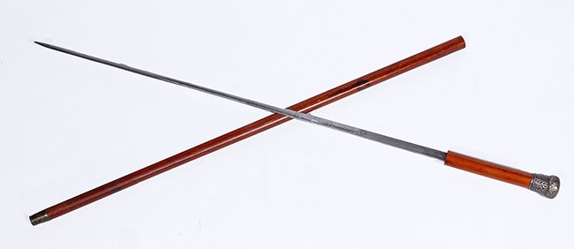 78. Silver Sword Cane- Ca. 1865- A British hallmarked: 78. Silver Sword Cane- Ca. 1865- A British hallmarked “J.H.” silver handle, rich malacca shaft, brass ferrule, 27” two-sided blade with push/pull mechanism.Blade engrave "Peace with Honor" on on