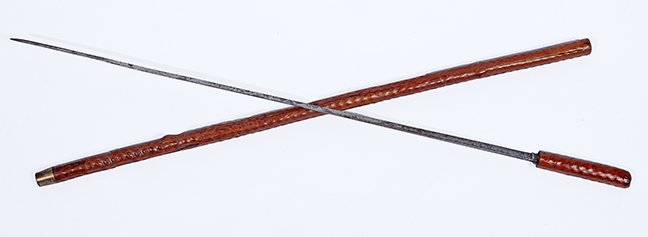 80. Exotic Wood Sword Cane- Ca. 1900- a nice natural: 80. Exotic Wood Sword Cane- Ca. 1900- a nice natural tree branch Asian cane, metal ferrule, 26” triangular blade with push/pull mechanism. H.- 4 ½” x 1” O.L.- a 132 ½” $250-$350.