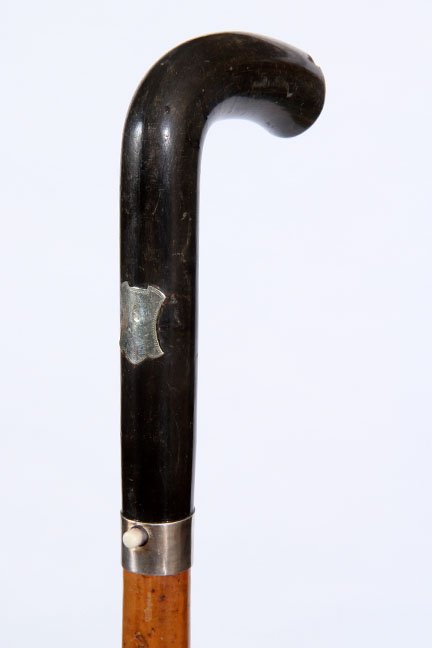 38. Horn Sword Cane- Ca. 1870- An American buffalo coin: 38. Horn Sword Cane- Ca. 1870- An American buffalo coin handle with blank silver cartouche, push button lock mechanism in working condition with a 12” four-sided blade, stepped malacca shaft and an 