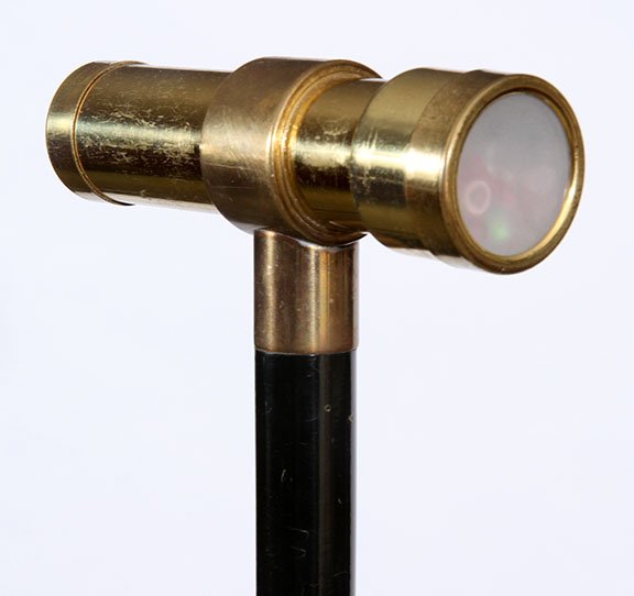 74. Kaleidoscope Cane- 20the Century- A brass working: 74. Kaleidoscope Cane- 20the Century- A brass working kaleidoscope cane with original lenses, brass bracket and collar, ebonized shaft and brass ferrule. $300-450