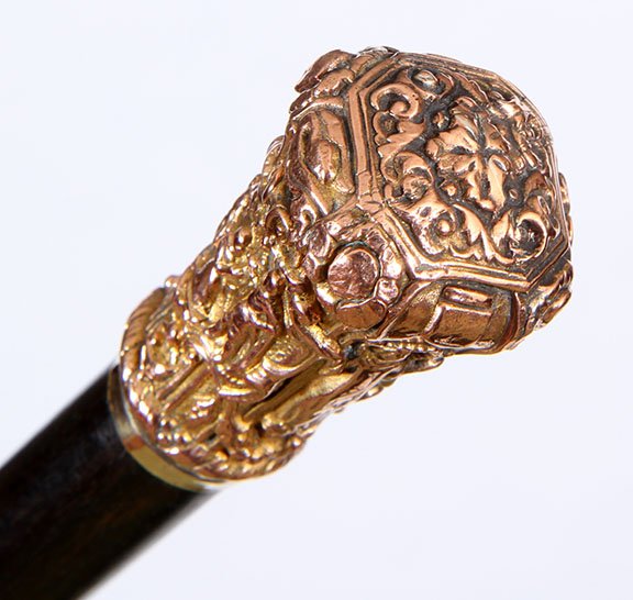 108. Rose Gold Dress Cane- Ca. 1850- A high relief cast: 108. Rose Gold Dress Cane- Ca. 1850- A high relief cast rose gold handle which has various medieval scenes, attached rose gold collar, ebony shaft and a steel ferrule. H.- 2 ½ x 1 ¼” O.L.- 34 ½��