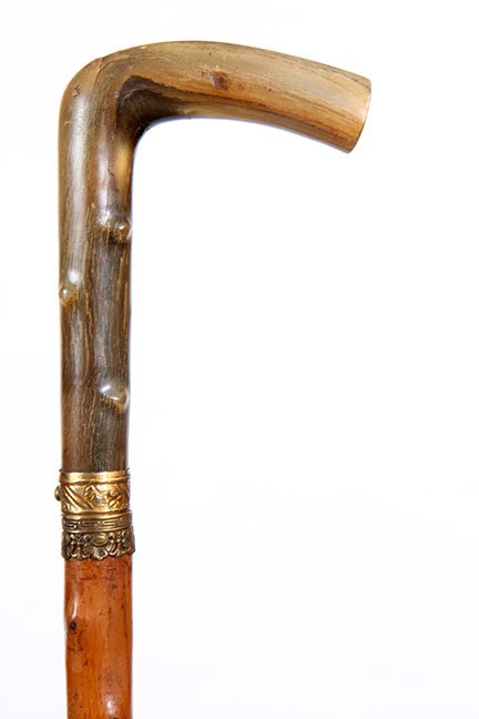 112. Horn Sword Cane- Ca. 1875- A twigspur horn handle,: 112. Horn Sword Cane- Ca. 1875- A twigspur horn handle, pair of ornate gold-filled collars, push and lock mechanism with a 26” blued and gold blade, natural twigspur shaft and a brass ferrule. H.- 3