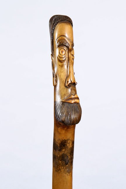 129. Johnny Winter Rock and Roll Cane- Dated 1979- A: 129. Johnny Winter Rock and Roll Cane- Dated 1979- A one piece carved staff with copper nose and earrings signed “T-ACE”, paint decorated throughout and a metal ferrule. This was an unpaid lot fr