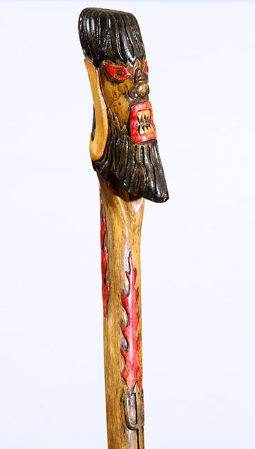 130. Johnny Winter Devil Rock and Roll: 130. Johnny Winter Devil Rock and Roll Cane- 20th Century- A fiercely carved devil figure with downward horns, pitchfork and flames carved on the shaft and a metal ferrule. This was an unpaid lot fr