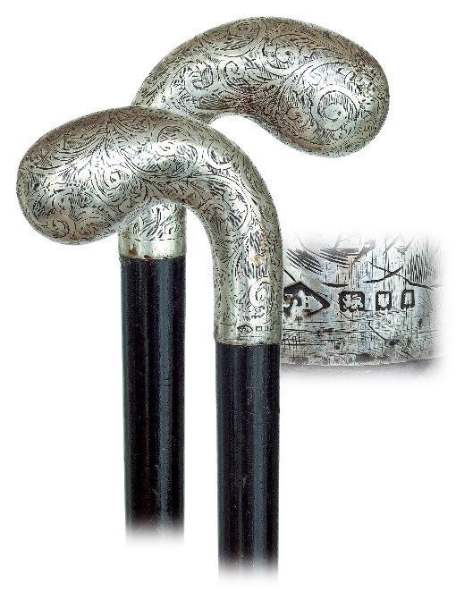 31. Silver Dress Cane-Ca. 1890-Large and: 31. Silver Dress Cane-Ca. 1890-Large and well-proportioned silver pistol shaped knob with dense scrolls engraving, ebony shaft and a metal ferrule. Full set of obscured London silver hallmarks. This c