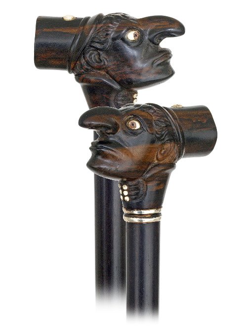 78. Whimsical Man Ebony Dress Cane-Ca. 1880-Could be a: 78. Whimsical Man Ebony Dress Cane-Ca. 1880-Could be a clown or just a man of the street, bone inlay and glass eyes, ebony shaft with a silver collar and a horn ferrule.-H. 3 ¼” x 2 ¼”, O.L. 37�