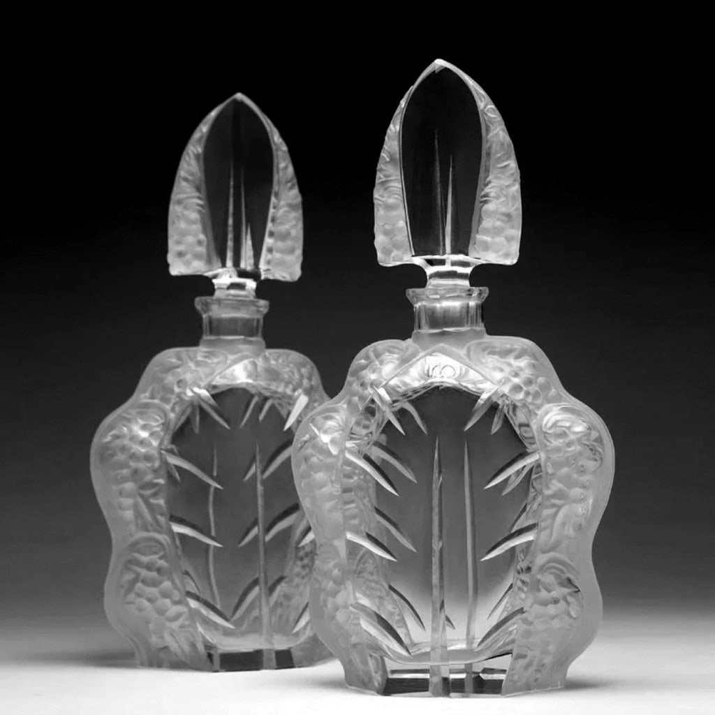 French Art Deco Glass A pair of decanters with stoppers: Timeless design - Top Qality Collectible Art Deco Glass. Dimensions: 11.25'' H x 5.5'' W x 3.5'' D. Fast delivery time worldwide: 2-4 days.