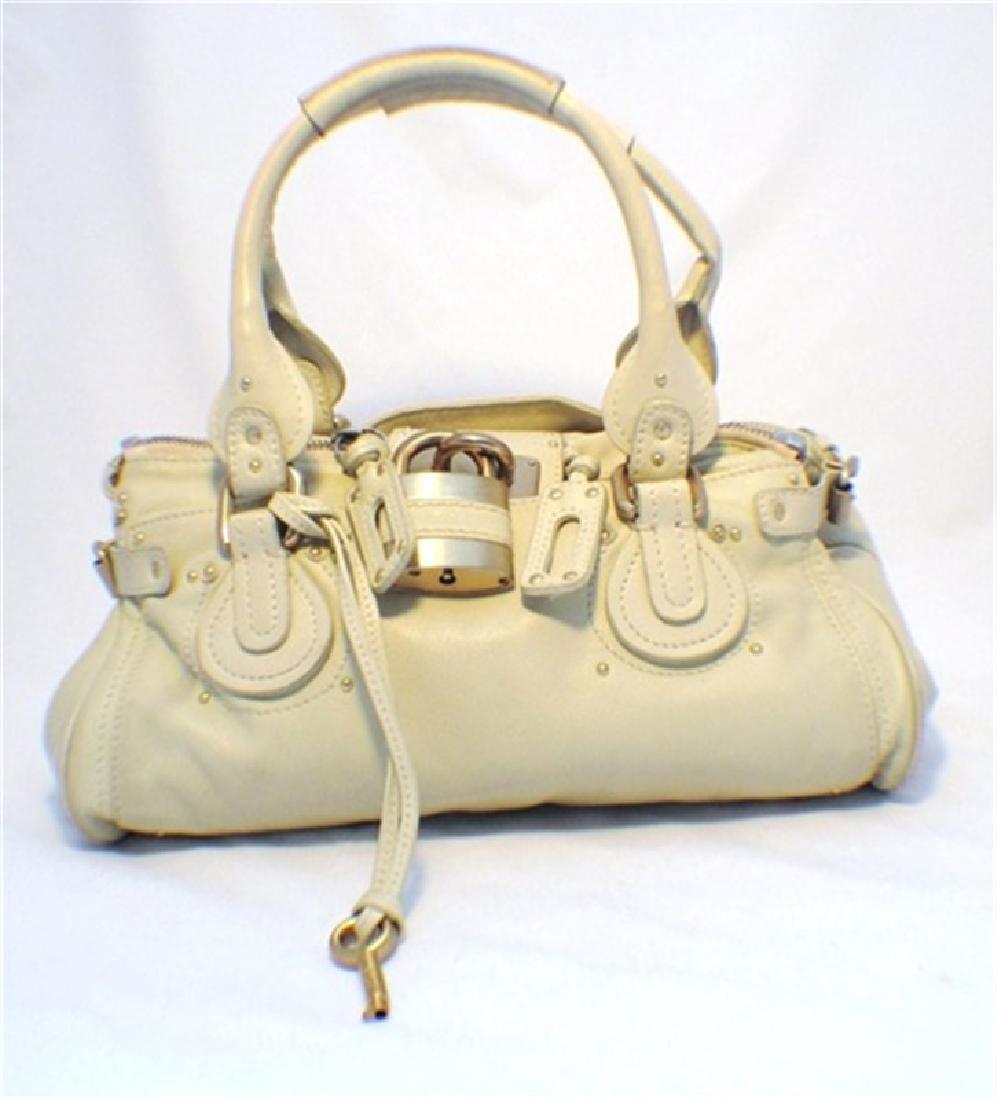 Chloe Beige Leather Handbag: This gorgeous Chloe handbag is sure to carry you through any season. The beautiful beige leather exterior is in wonderfully condition and features matte gold hardware. The double zipper closure held o