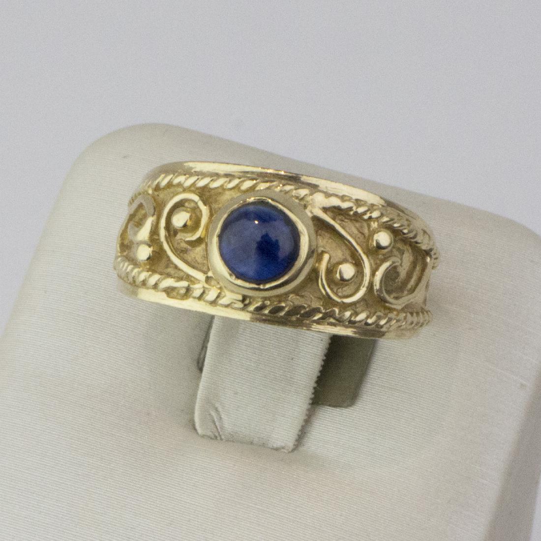 14K Yellow Gold Byzantine style blue sapphire Ring: 14K Yellow Gold Byzantine style blue sapphire Ring Gold : 14 Karat Yellow Gold Ring Size : 7 US Ring Weight : 7.50 g Stone : 1 Round Cabochon Blue sapphire Come With : Jewelry Box #RK111