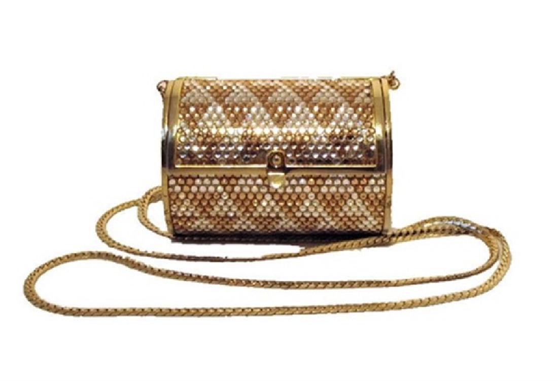 Judith Leiber Swarovski Cylinder Minaudiere: This beautiful Judith Leiber piece is in good pre-owned condition. The exterior features stunning clear and tan Swarovski crystals trimmed with gold hardware. The lift latch closure opens to a gold le