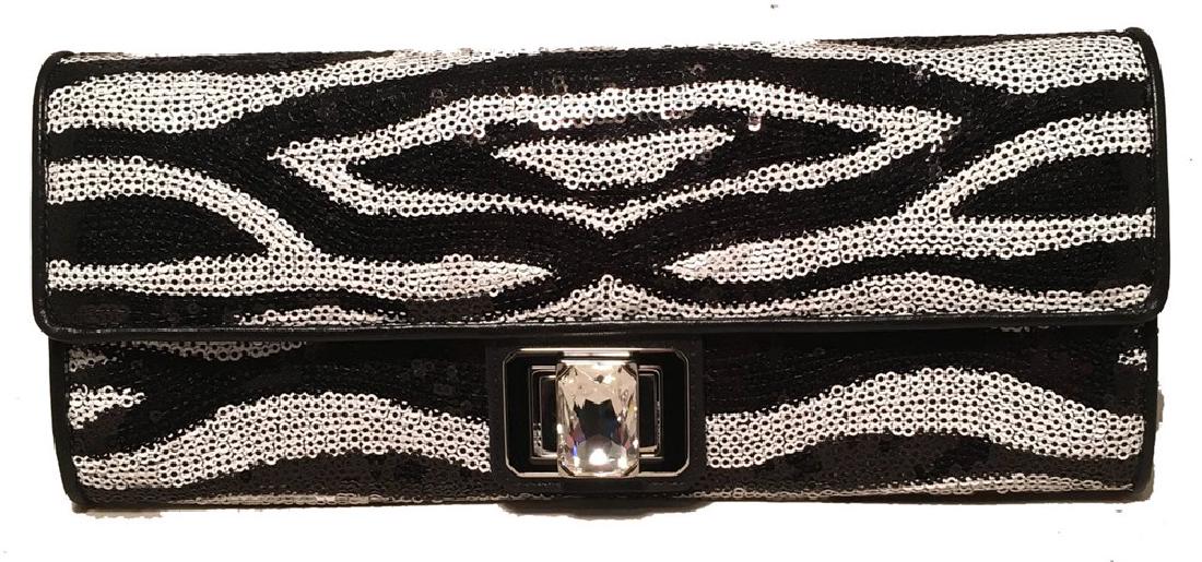 Judith Leiber Zebra Stripe Sequin Clutch: Beautiful Judith Leiber Zebra Stripe Sequin Clutch in excellent condition. Black and White zebra stripe sequin pattern exterior trimmed with black leather, silver hardware and a front twist lock large