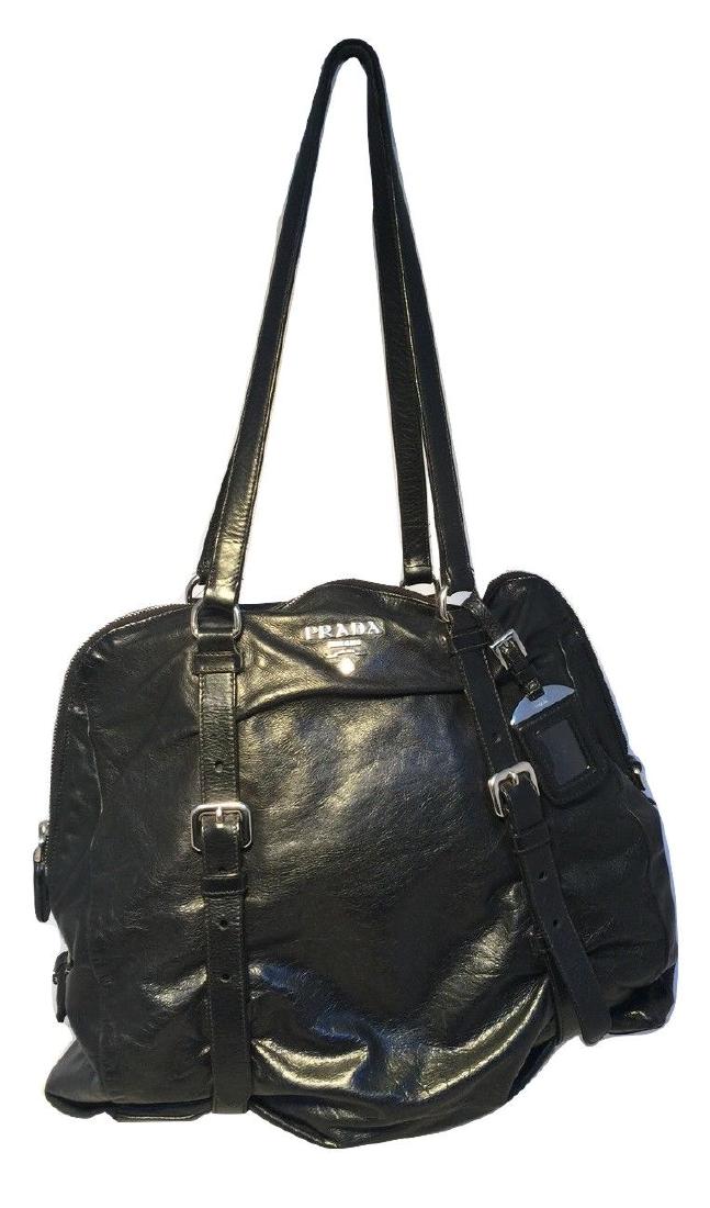 Prada Black Leather Strappy Shoulder Bag: Gorgeous Prada Black Leather Shoulder Bag Tote in excellent condition zipper closure opens to a black nylon lined interior with one side slit pocket and one side zippered pocket. A ton of space for ev