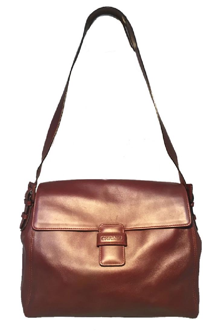 Chanel Maroon Leather Top Flap Shoulder Bag: Gorgeous Chanel leather flap shoulder bag in excellent condition. Maroon leather with buckled side shoulder strap details. Front loop closure opens single flap style to a brown nylon lined interior. T
