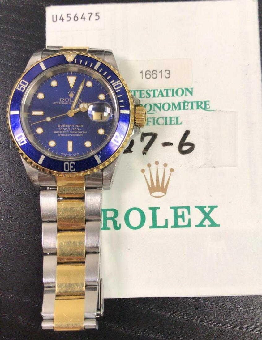 Pre-Owned Rolex Submariner Date 16613: Rolex Submariner Date Stainless Steel and 18K Yellow Gold Bezel with Blue dial Oyster Bracelet 40mm Watch Features: Brand: Rolex Model : Submariner Model Number: 16613 Gender: Men's Movement